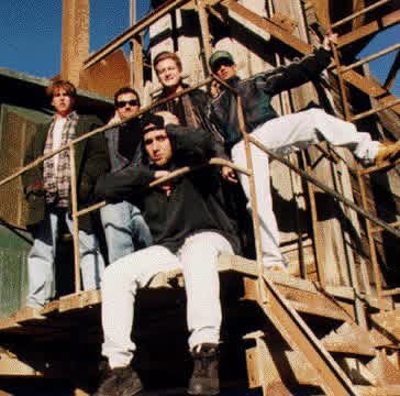 Group photo of the five members of GAGE gathered on a rusted steel staircase.